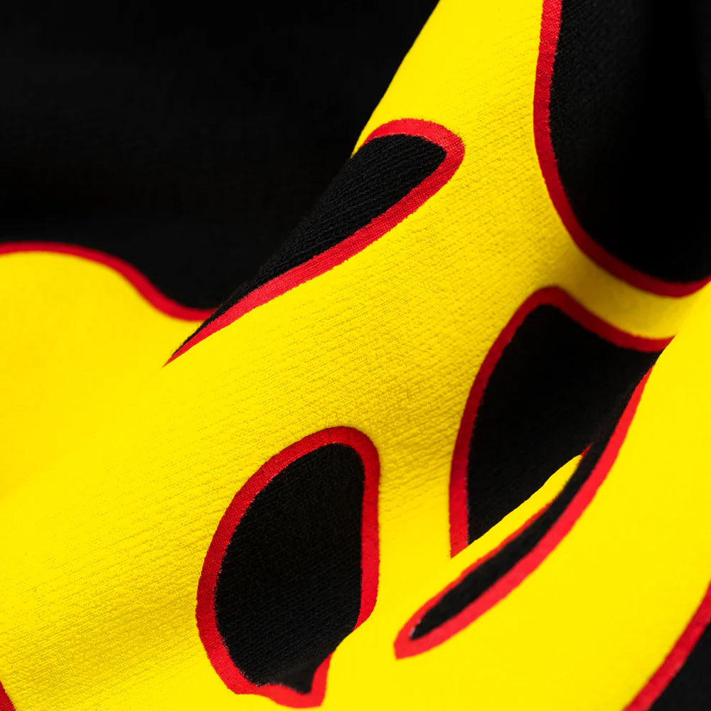 Close-up of a yellow and black object with red accents