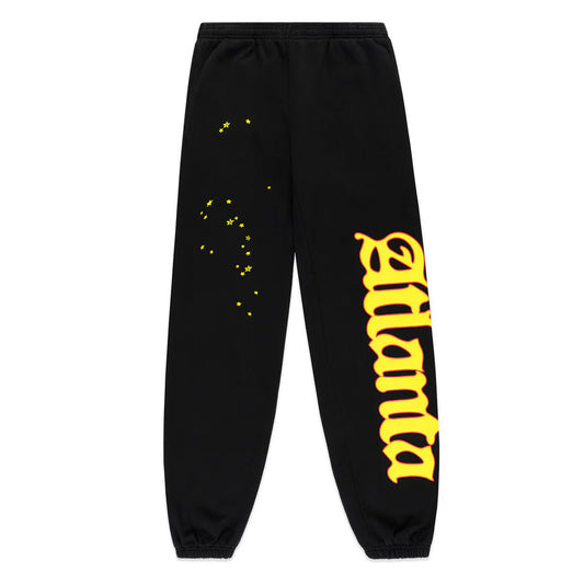 Black sweatpants with yellow text on a white background