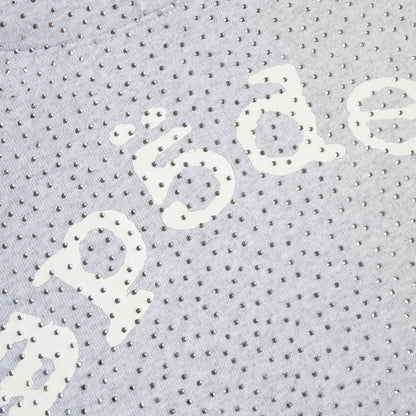 Close-up of a textured fabric with 'sp5der' printed on it.