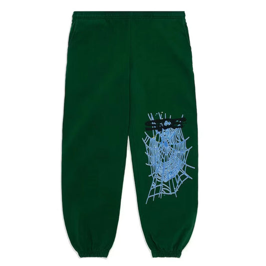 Green sweatpants with a spider web and blue spider design on a white background