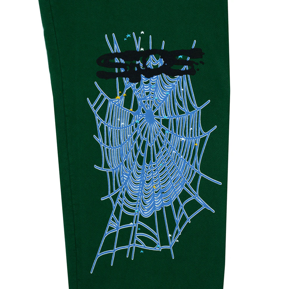 Green sweatpants with a spider web design on a white background